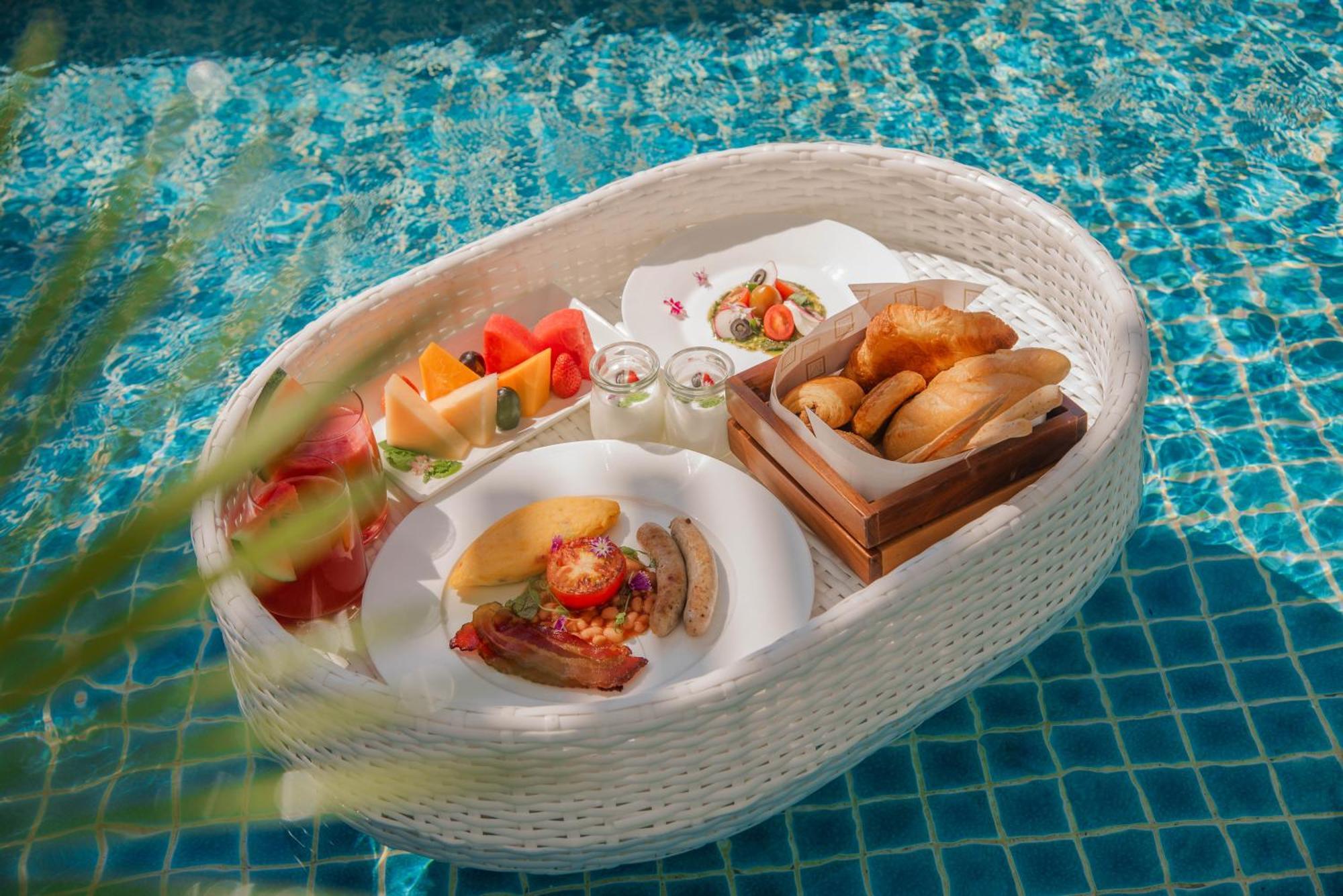 Mai House Saigon Hotel Хошимін Екстер'єр фото A floating breakfast at a resort in Bali, Indonesia